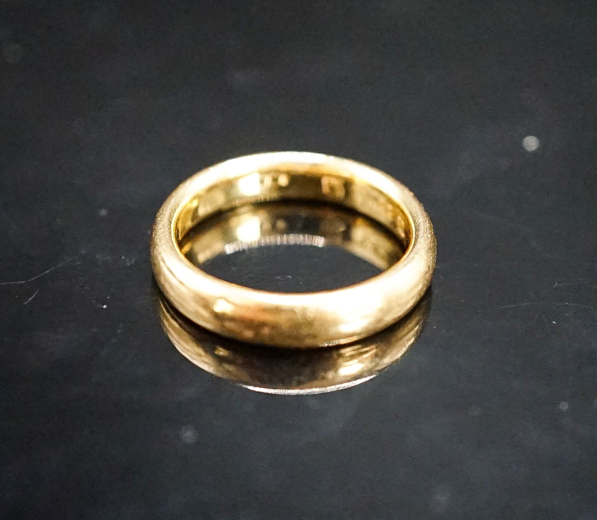 A 22ct. yellow gold wedding band, size L, 6.4 grams.